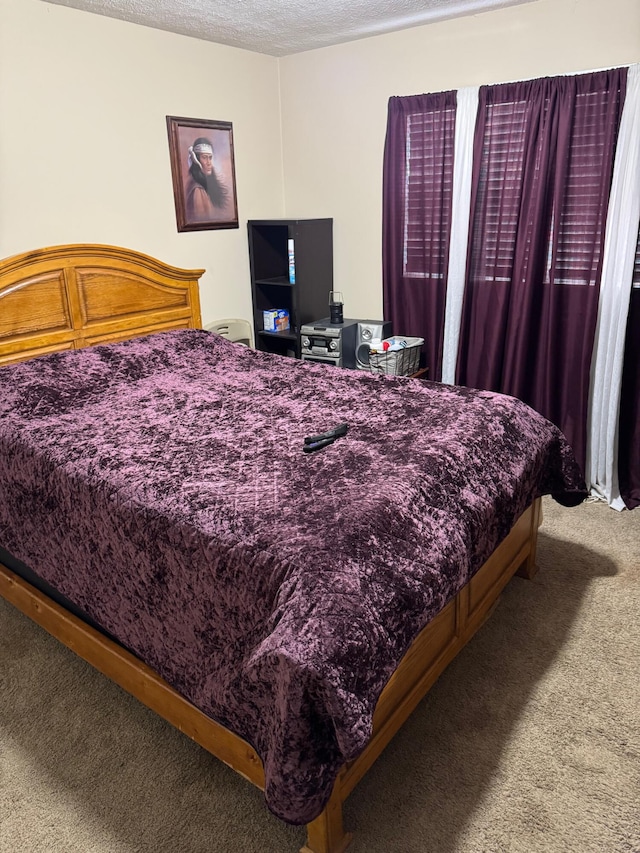 bedroom featuring carpet floors and a textured ceiling