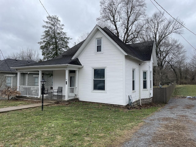 view of front of house featuring covered porch and a front lawn