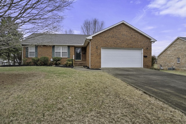 ranch-style house featuring a garage and a front lawn