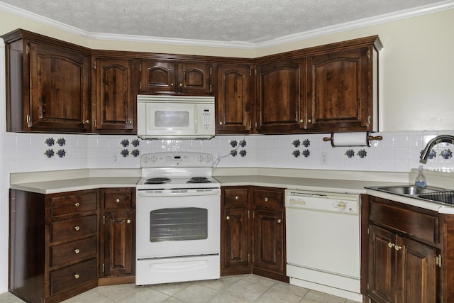 kitchen featuring tasteful backsplash, white appliances, sink, and dark brown cabinets