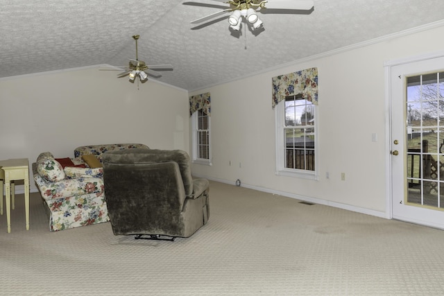 carpeted living room featuring ceiling fan, vaulted ceiling, ornamental molding, and a textured ceiling