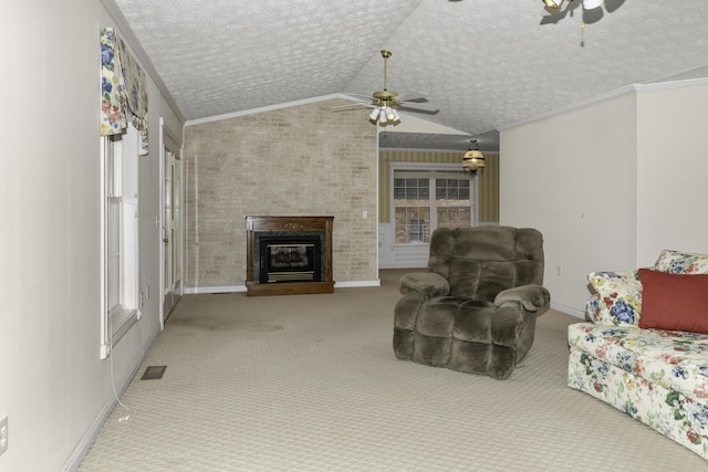 carpeted living room with ceiling fan, ornamental molding, vaulted ceiling, and a textured ceiling