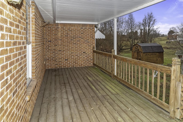 wooden terrace with a storage shed