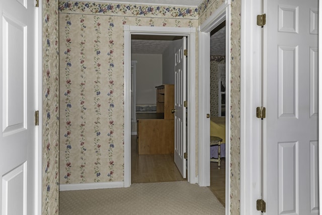 corridor featuring light colored carpet