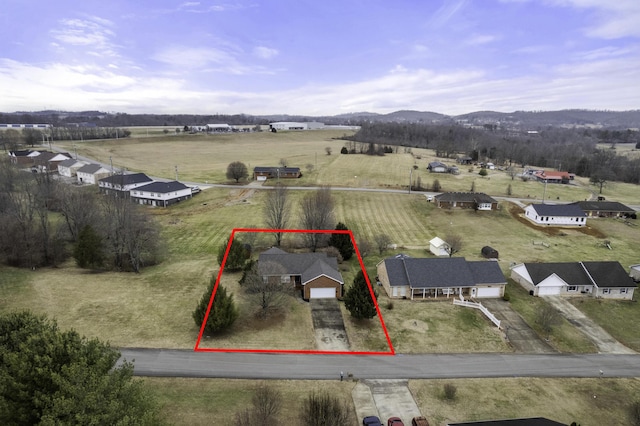 birds eye view of property with a mountain view and a rural view