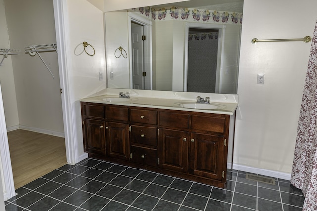 bathroom with vanity and tile patterned flooring