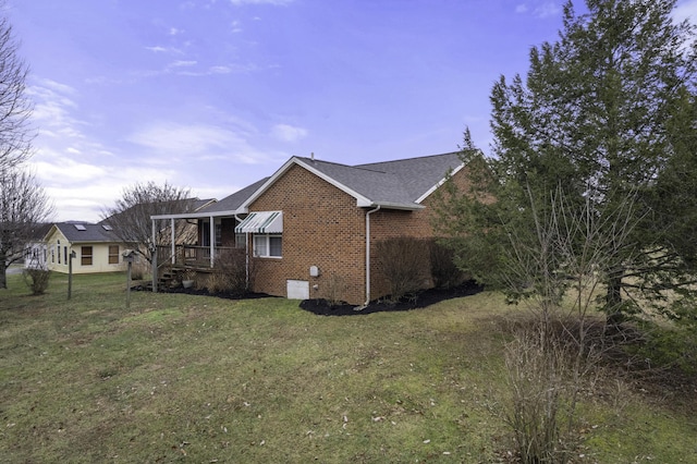 view of side of property featuring a yard