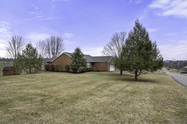 view of front of property with a garage and a front lawn