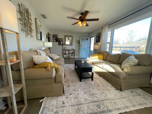 living room with hardwood / wood-style flooring and ceiling fan