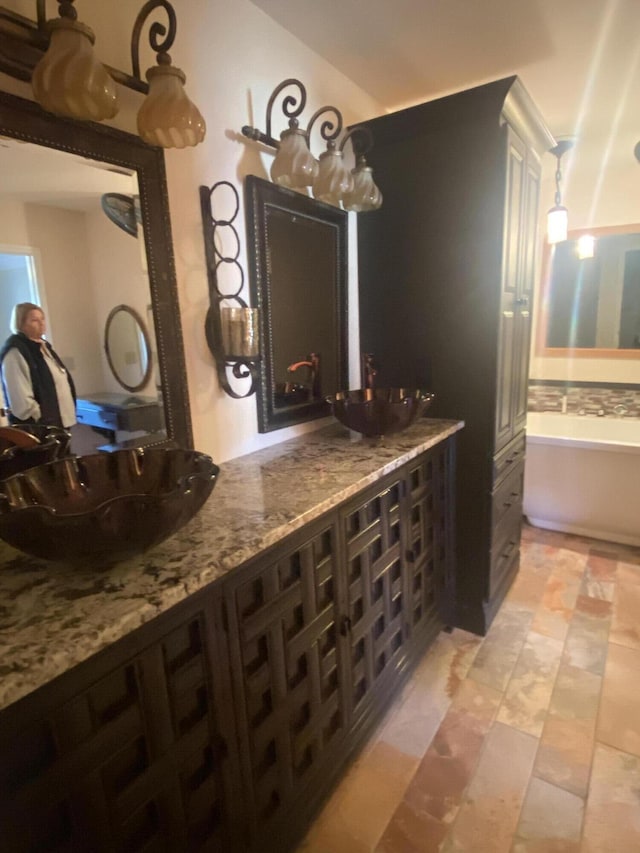 bathroom featuring a tub to relax in and sink