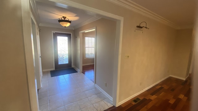 foyer featuring light tile patterned floors and ornamental molding