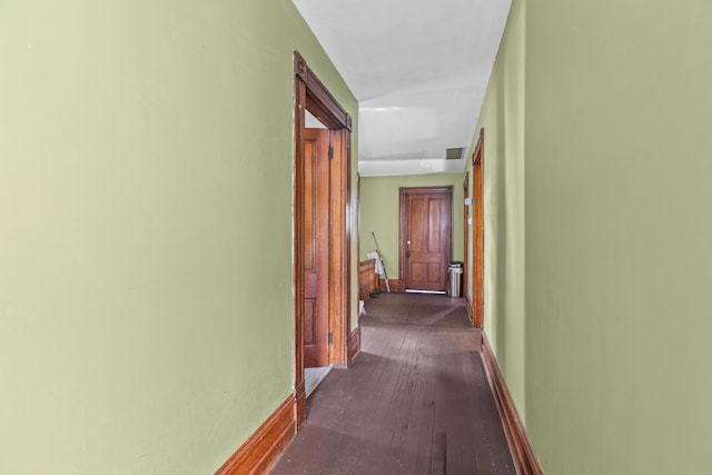 corridor with dark hardwood / wood-style floors