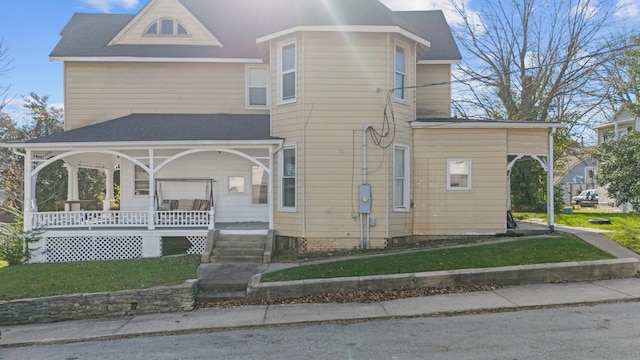 view of front of home featuring a porch and a front lawn