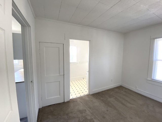 unfurnished room with dark carpet and ornamental molding