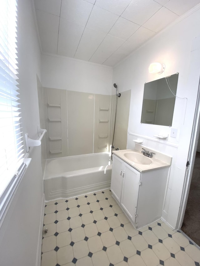 bathroom with vanity, tub / shower combination, a healthy amount of sunlight, and ornamental molding