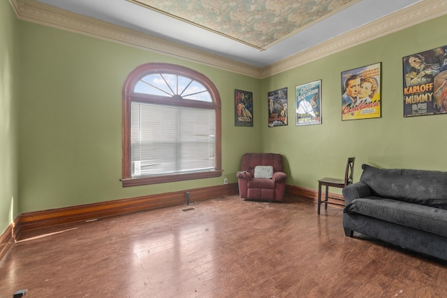 living area with hardwood / wood-style flooring and ornamental molding