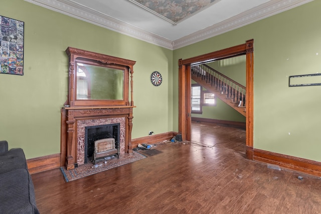 living room featuring a tile fireplace, crown molding, and dark hardwood / wood-style floors