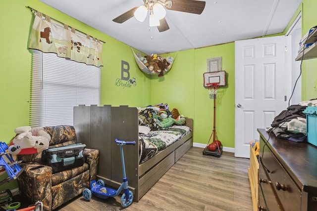 bedroom featuring hardwood / wood-style floors and ceiling fan