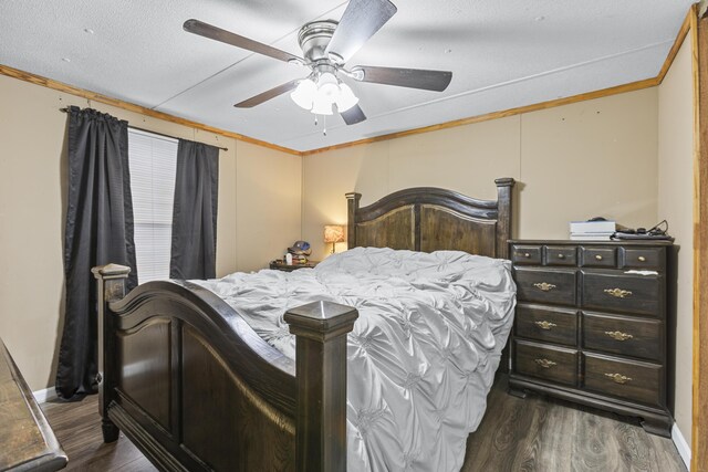 bedroom with crown molding, ceiling fan, and dark hardwood / wood-style flooring