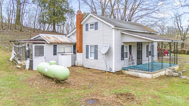 view of side of home with a lawn