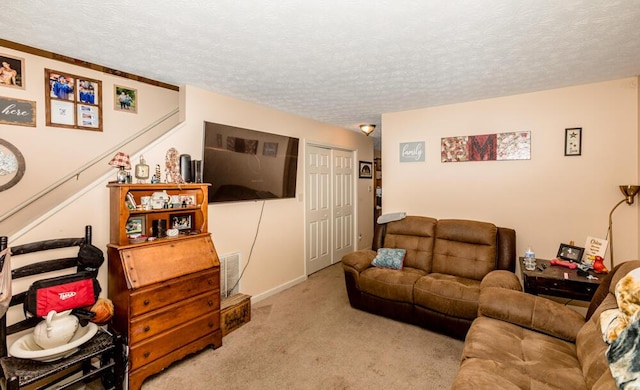 carpeted living room featuring a textured ceiling