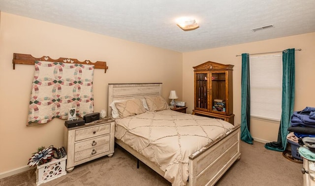 carpeted bedroom featuring a textured ceiling