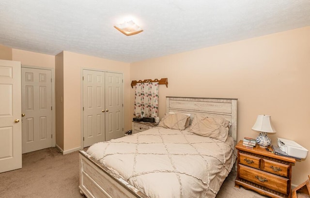 carpeted bedroom featuring a closet and a textured ceiling