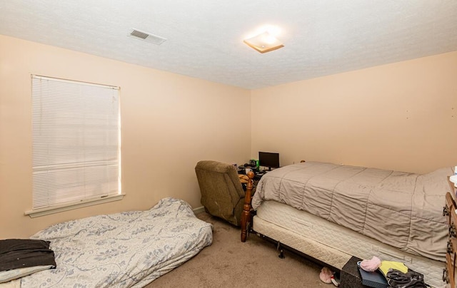 carpeted bedroom with a textured ceiling