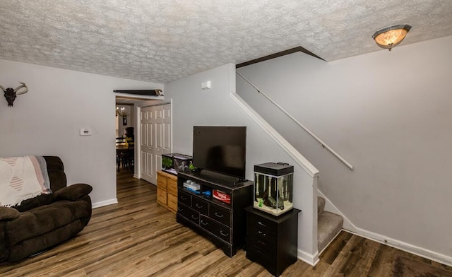 living room with hardwood / wood-style floors and a textured ceiling