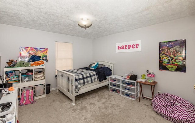 bedroom with light carpet and a textured ceiling