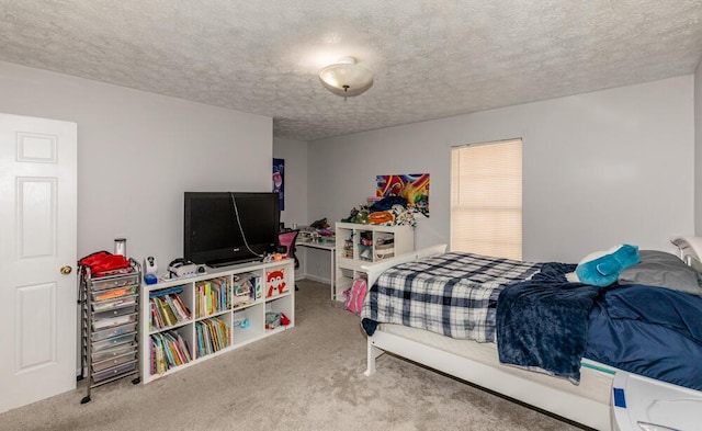 bedroom with a textured ceiling and carpet flooring