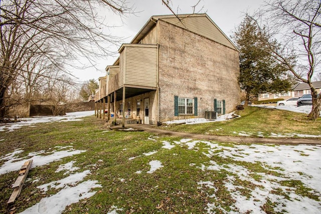 view of snow covered exterior featuring a lawn