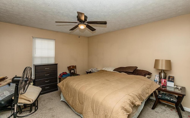 bedroom featuring ceiling fan, light carpet, and a textured ceiling