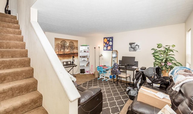 carpeted living room featuring a textured ceiling