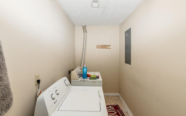 washroom with electric panel, washer and clothes dryer, and a textured ceiling