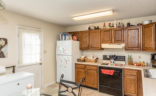 kitchen with range with electric stovetop and white refrigerator