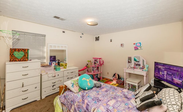 bedroom featuring carpet floors and a textured ceiling