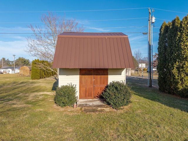 view of outbuilding with a yard