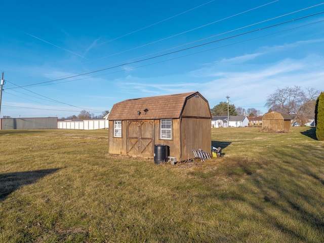 view of outbuilding featuring a yard