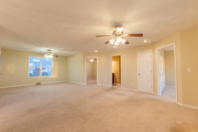 unfurnished room featuring light carpet and ceiling fan