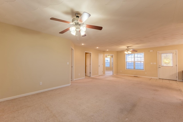 unfurnished room with light carpet and ceiling fan