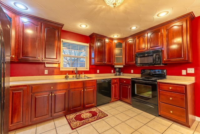 kitchen with light tile patterned flooring, sink, and black appliances