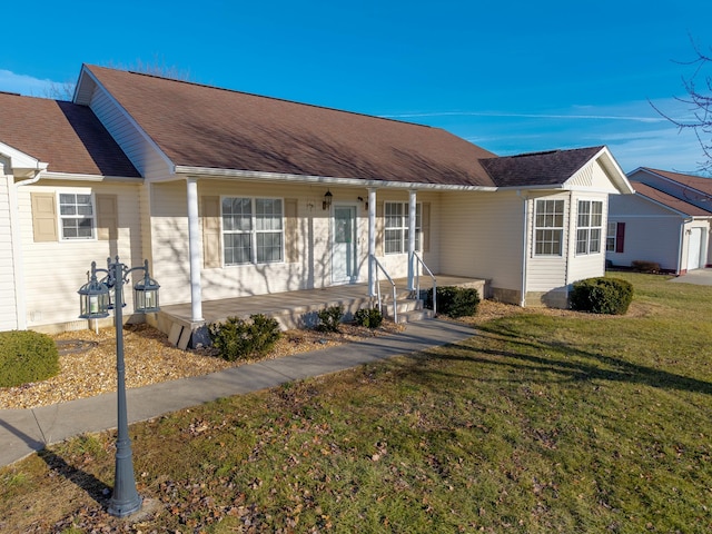 single story home featuring a front lawn and covered porch