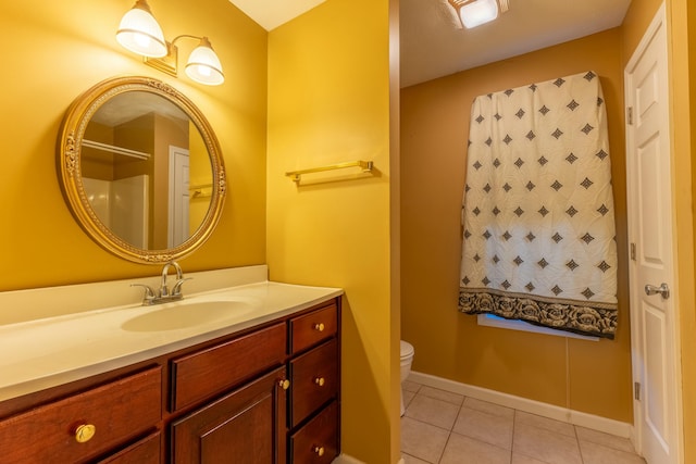 bathroom featuring vanity, toilet, and tile patterned flooring