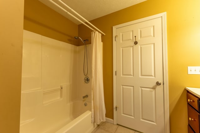 bathroom with shower / bath combination with curtain, tile patterned floors, vanity, and a textured ceiling