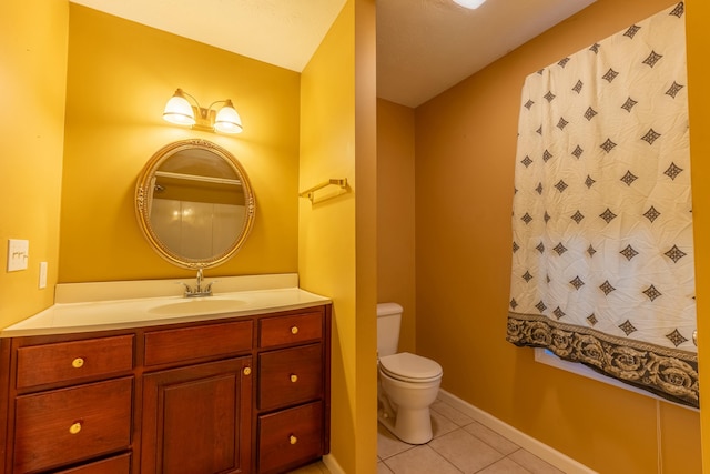 bathroom with vanity, tile patterned floors, and toilet