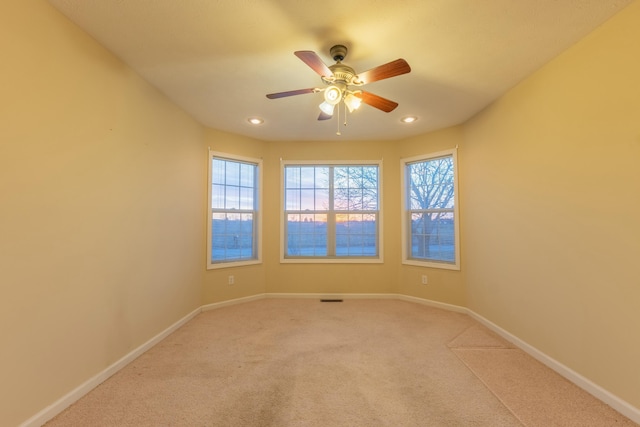 spare room with carpet floors and ceiling fan