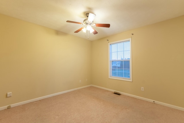 spare room with carpet flooring and ceiling fan