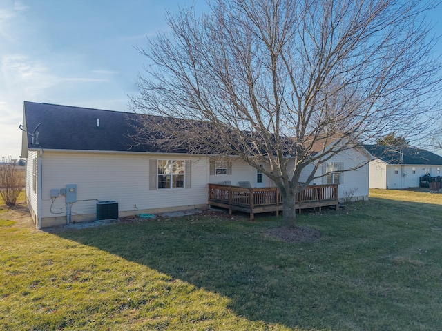 back of property featuring central AC, a deck, and a lawn