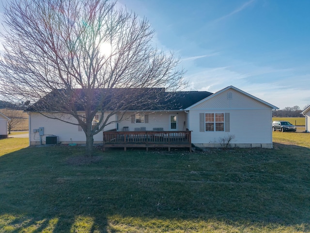 back of house featuring a wooden deck, cooling unit, and a lawn